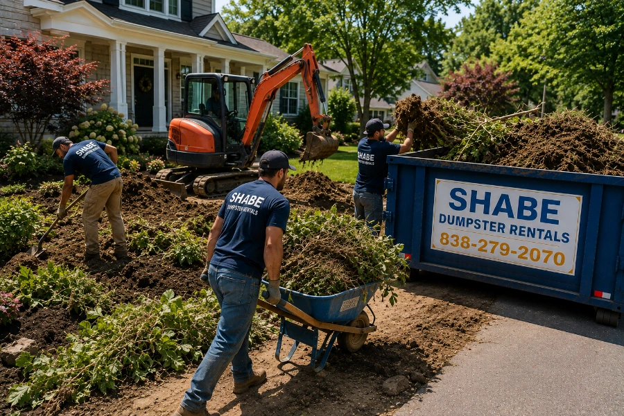 Residential landscaping renovation with soil vegetation and debris prepared for dumpster removal